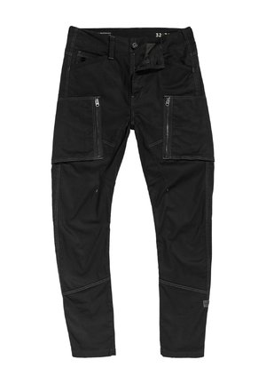 Black cargo pants made of durable fabric, featuring multiple zippered pockets, contrasting stitching, and a tapered leg design.