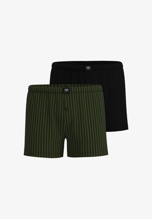 Deux paires de boxers pour hommes, une unie noire et une vert foncé avec des rayures blanches verticales, toutes deux avec des ceintures élastiques.