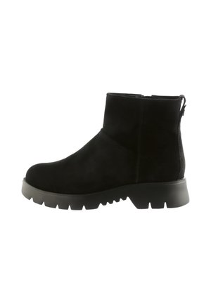 Black suede ankle boot with chunky treaded sole and side zipper, featuring a pull tab at the back for easy wear.