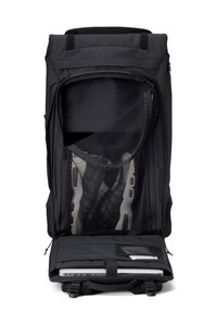 Black backpack with a zippered opening showcasing a mesh compartment and a padded section for computer storage. Durable fabric, minimalistic design.