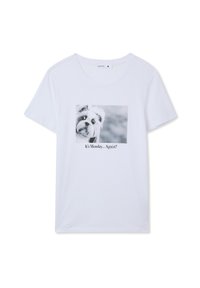 T-shirt bianca in cotone con un'immagine in bianco e nero di un cane e la scritta "È lunedì... di nuovo?" stampata sotto il grafico.