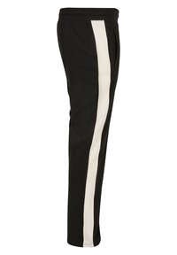 Pantaloni de jogging negri cu o dungi verticale albe pe partea laterală. Au un talie elastică și un buzunar lateral pentru comoditate.