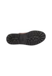Suela de zapato de goma negra con un patrón de agarre texturizado, con surcos pronunciados y el logo "JOOP!" grabado cerca del talón.