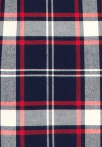 Wool fabric featuring a dark navy, red, and white plaid pattern, with bold intersecting lines and a soft texture.