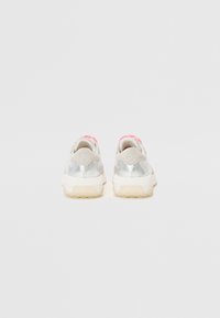 Metallic silver sneakers with pink accents, textured heel, and a rubber sole. Rounded shape with padded collar and pull tab at the back.