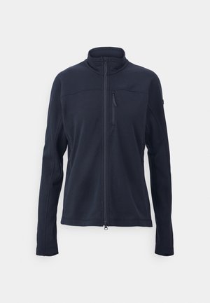 Jūrininkų zip-up švarkas, pagamintas iš tekstūrinio audinio, su aukštu apykakle, užtrauktuku užsegama kišene ant krūtinės ir šoninėmis kišenėmis.