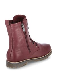 Bordaux leren enkellaars met vetersluiting aan de voorkant en een rits aan de zijkant, gestructureerd oppervlak, rubberen zool met grip en gestikte details.