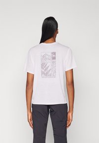 Tricou gri deschis cu un design grafic pe spate, având motive de munte și natură, cu mâneci scurte și o croială lejeră.