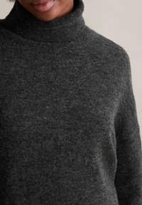 Dunkelgrauer Rollkragenpullover aus weichem, strukturiertem Stoff, mit lässiger Passform und gerippten Kragen details.