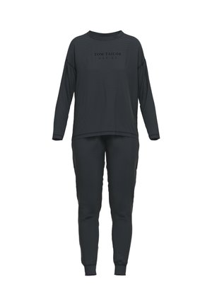 Top negro de manga larga con rayas horizontales y corte holgado, combinado con pantalones tapered a juego. La tela parece suave y ligera.