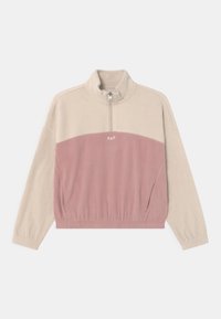Half-zip pullover in beige en lichtroze fleece. Voorzien van een hoge kraag, elastische tailleband, zijzakken en een geborduurd logo aan de voorkant.
