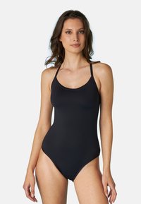 Costume da bagno intero nero con spalline sottili, scollatura rotonda e una texture liscia e opaca. Presenta un'apertura alta sulla gamba.