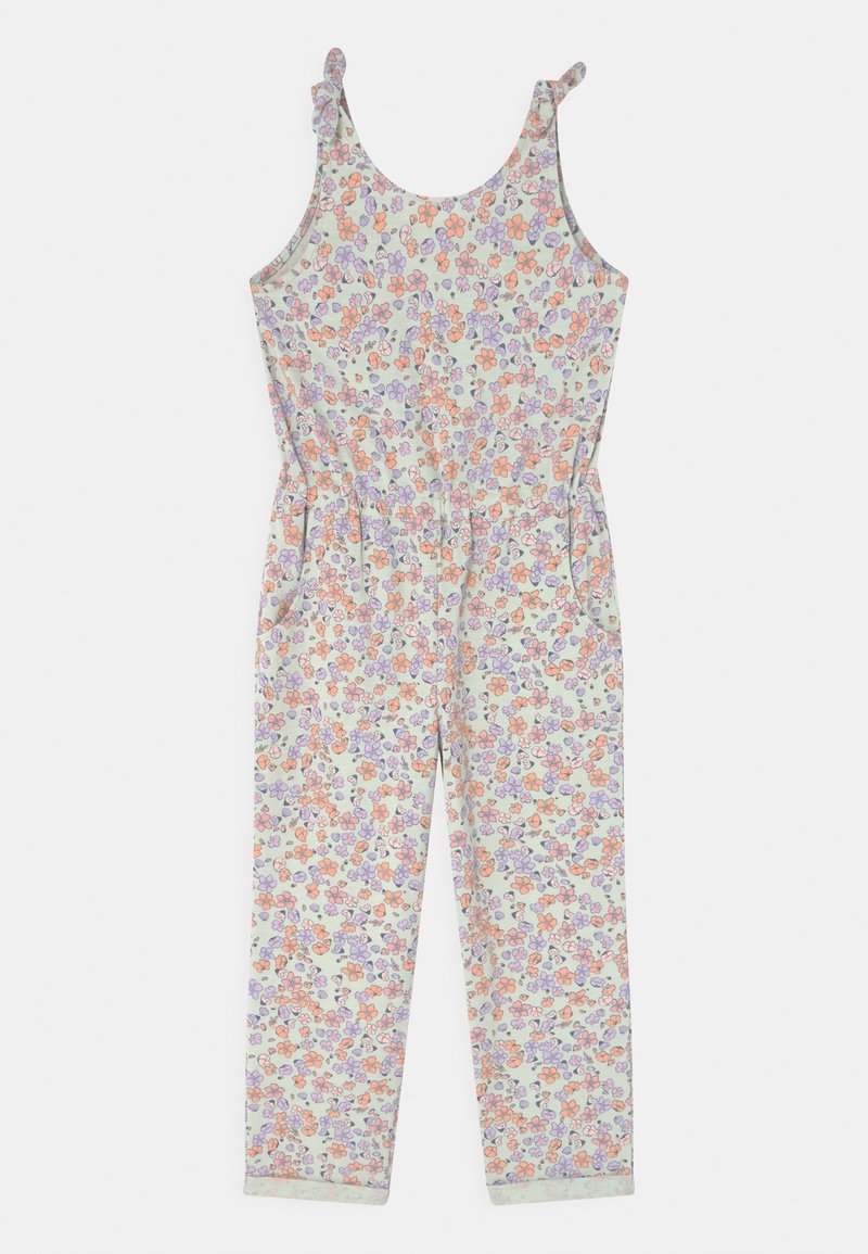 Salopette florale dans des couleurs pastel avec des fleurs orange, violettes et vertes. Elle possède des bretelles réglables et deux poches latérales. Tissu léger.