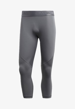 Leggings de compression Adidas gris avec panneaux cousus et taille élastique à logo, longueur raccourcie se terminant sous le mollet.