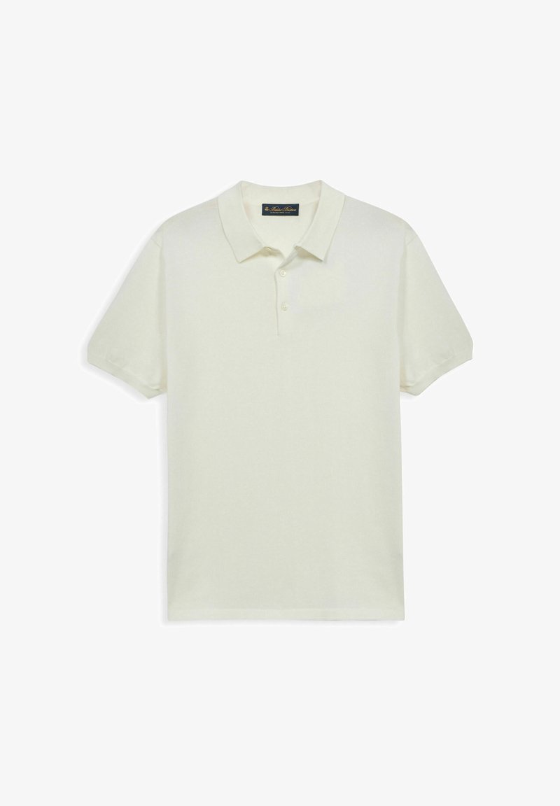 Polo à manches courtes de couleur crème avec col et trois boutons, présenté à plat sur un fond blanc.