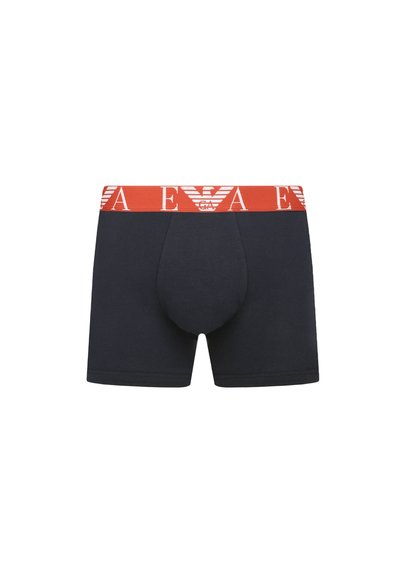 Navy boxer briefs with a red elastic waistband featuring white logo text and emblem. Soft, stretchable cotton fabric with a fitted shape.