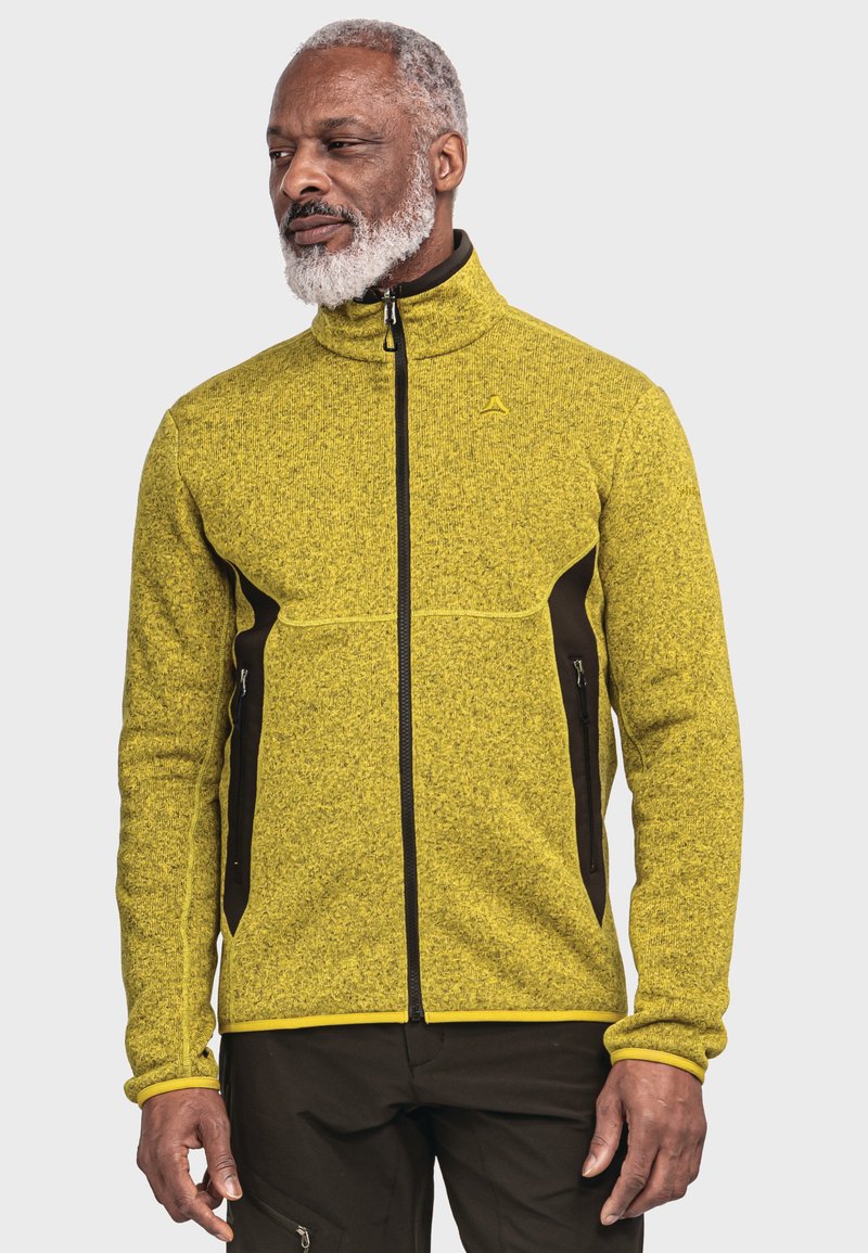 Fleecejacke in leuchtendem Gelb mit strukturiertem Finish. Schwarze Akzente an den Seiten und mit Reißverschlüssen ausgestattet. Hoher Kragen und durchgehender Reißverschluss.