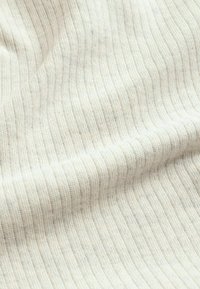 Textile fabric with fine, vertical stripes in cream and beige. Soft texture with a slight stretch, showcasing a ribbed pattern.