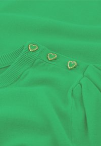 Groene trui met een zachte brei-textuur, voorzien van drie gouden hartvormige knopen en een glad ontwerp van de kraag.