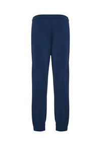 Pantalon de survêtement bleu marine avec taille et poignets élastiques, fabriqué en matériau doux. Caractérisé par une texture lisse et une coupe fuselée.