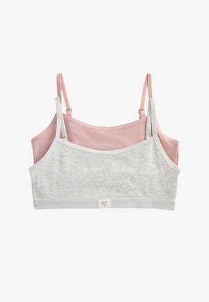 Dwa prążkowane bawełniane topy bralette z regulowanymi ramiączkami, jeden w jasnoszarym, drugi w delikatnym różowym, ułożone warstwowo na białym tle.