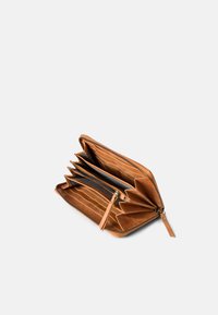 Brown leather zip-around wallet open, showing multiple card slots, central zipper coin compartment, and accordion-style sections.