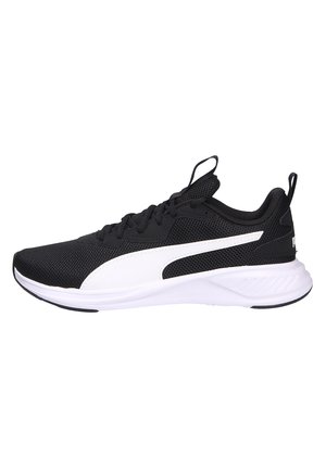 Baskets athlétiques basses noir et blanc avec dessus en mesh, bande logo Puma blanche et semelle rembourrée.