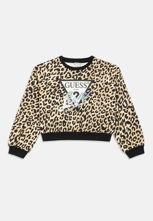 Dolg rokav kratka majica z leopardjim vzorcem, črnimi manšetami, ovratnikom, spodnjim robom ter belim trikotnim logotipom z napisom "GUESS U.S.A." in holografskim napisom "Love."