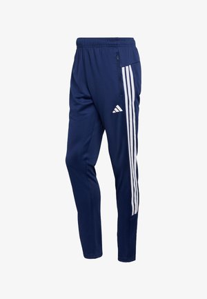 Navy joggers gemaakt van lichtgewicht stof met een wit driedriehoekig ontwerp aan de zijkanten en een elastische tailleband, met een zak met rits.