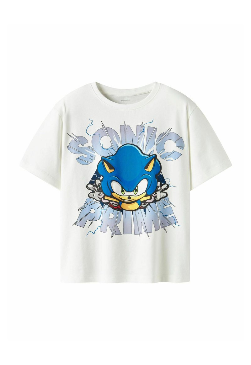 Hvid bomulds t-shirt med et stort blåt tegneseriefigur med grønne øjne, omgivet af teksten "SONIC PRIME" i fede, stiliserede bogstaver.