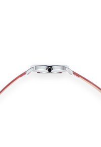 Montre ronde en acier inoxydable argenté avec un fin bracelet en cuir rouge et une couronne noire, affichant un design minimaliste et une surface lisse.