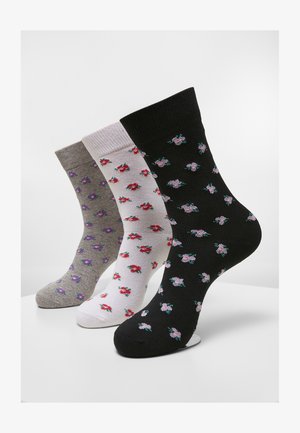 Tre par strømper i grå, hvid og sort, med små blomster mønstre i pink og lilla. Materialet ser blødt ud med ribbede kanter.