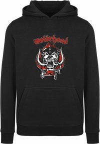 Black hoodie featuring a front graphic of a skull with tusks and the text “motörhead” in red. Material appears soft with a kangaroo pocket.