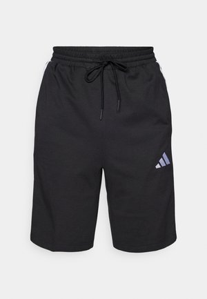 Melnas sportiskas šortos, kas izgatavoti no mīkstas, elpojošas auduma. Iezīmēta ar elastīgu jostu ar auklu un izteiksmīgu diagonālu logo.