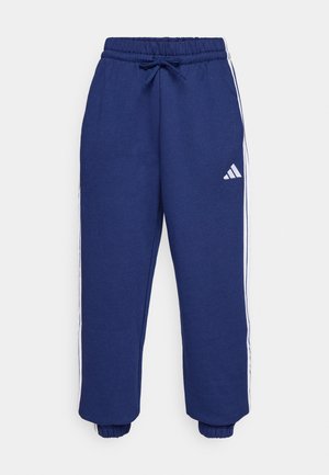 Marina idrottsbyxor gjorda av mjukt tyg, med vita sidostripes, elastisk midja med justerbar dragningssnodd och elastiska muddar.