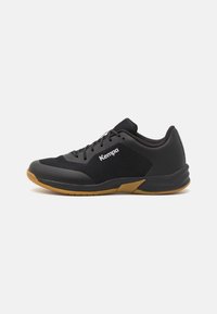 Black athletic shoe with a mesh upper and rubber sole. Features laces, a logo on the side, and a low-profile design with a textured finish.