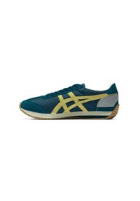 Teal athletic shoe with yellow accents, suede and mesh materials, low profile, lace-up design, rubber sole, and a gray heel section.
