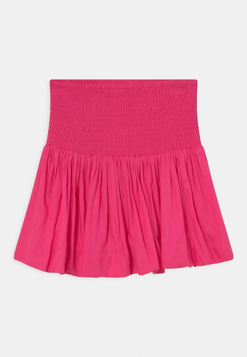 Jupe rose vif avec une large taille smockée et une partie inférieure froncée et évasée sur un fond clair.
