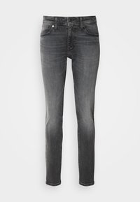 Grey denim jeans with a slim fit, featuring a mid-rise waist, tonal stitching, five pockets, and subtle fading. Classic button and zipper closure.