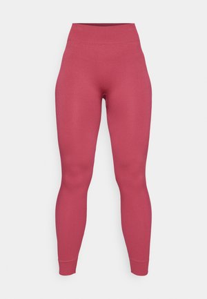 Leggings com nervuras em uma cor rosa sólida e cintura alta. O material parece elástico e ajustado, projetado para conforto e mobilidade.