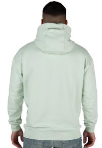 Felpa verde chiaro con una vestibilità morbida, dotata di un grande cappuccio e polsini a costine. Marchio "WRONG FRIENDS" sul retro, realizzata in un morbido materiale misto cotone.