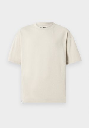 Lichtbeige katoenen t-shirt met een ronde halslijn en korte mouwen. Heeft een relaxte pasvorm en een minimalistisch ontwerp zonder patronen.
