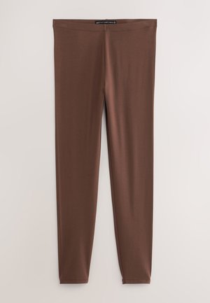 Brune, elastiske leggings lavet af blødt stof, med en tætsiddende pasform og uden synlige sømme, velegnet til afslappet eller atletisk brug.