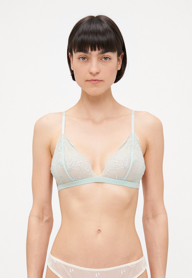 Vaaleansininen, läpikuultava pitsinen bralette, jossa on kukkaemmeltä, kolmiomaiset kupit, säädettävät hihnat ja pehmeä vyötärö.
