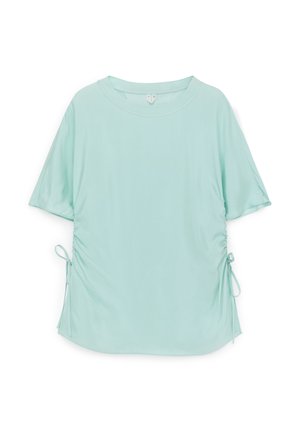 Camiseta de manga corta azul claro con cuello redondo y detalles de cordón lateral sobre fondo blanco.