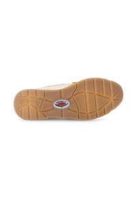 Schoenzool met een textuur van beige rubber, voorzien van een rond logo en een patroon van groeven voor grip en tractie.