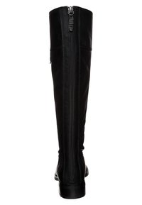 Botte montante en cuir noir avec fermeture éclair à l'arrière, texture lisse et bout arrondi. Présente des coutures discrètes le long des côtés.