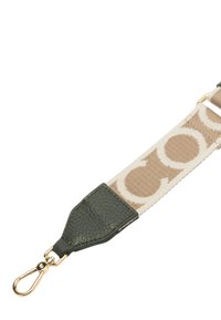 Cinghia in tela con motivo circolare beige e marrone, dotata di un'estremità in pelle verde e clip in oro per il fissaggio.