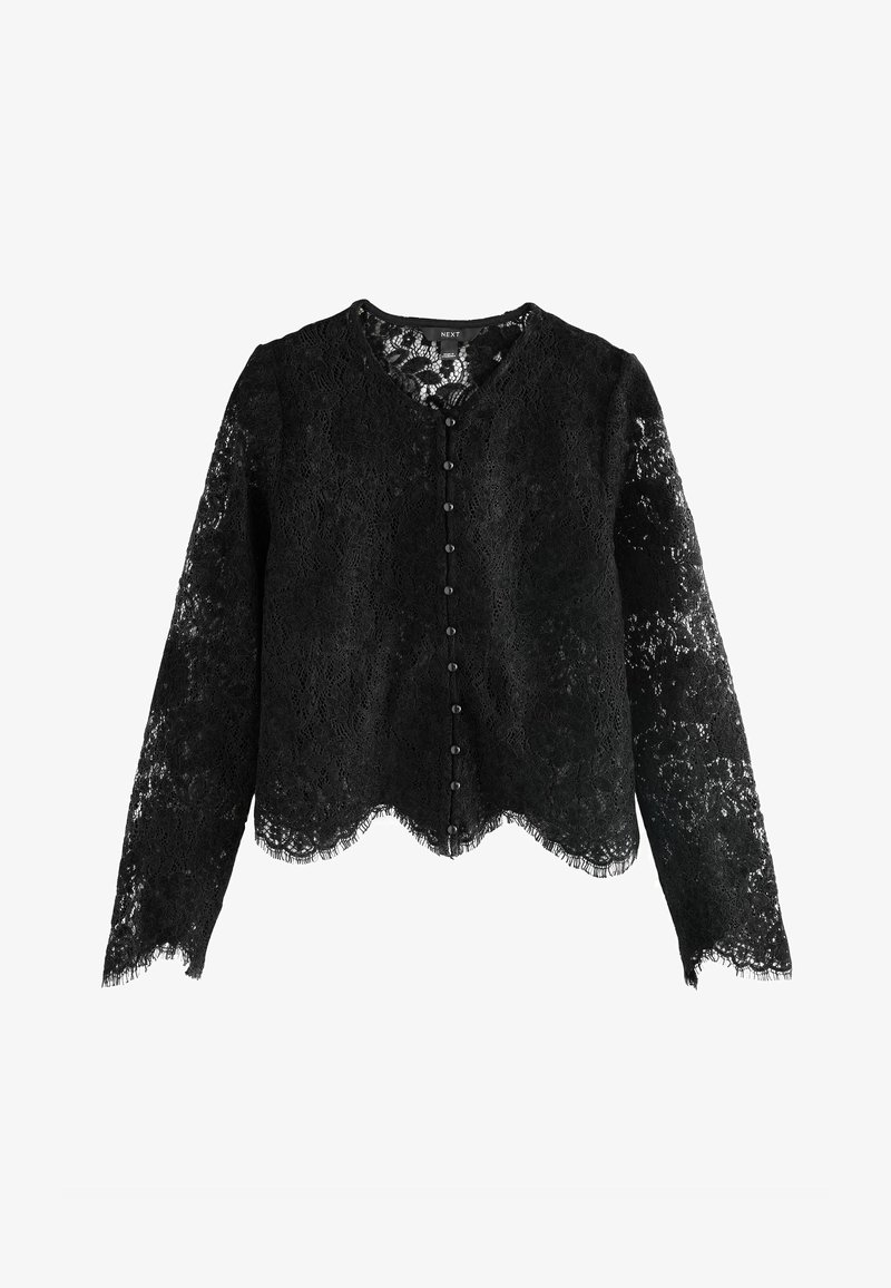 Sort spids cardigan med lange ærmer, en bølget kant og en række sorte knapper på fronten. Indviklet spidstekstur over hele.