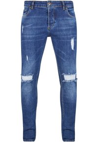 Tanekne kavbojke v temno modrem denimu, z odprtinami in poškodbami na kolenih. Klasičen pet-pocket dizajn z zadrgo in zankami za pas.